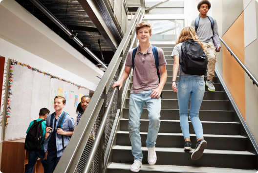 students walking the halls and stairs of a school