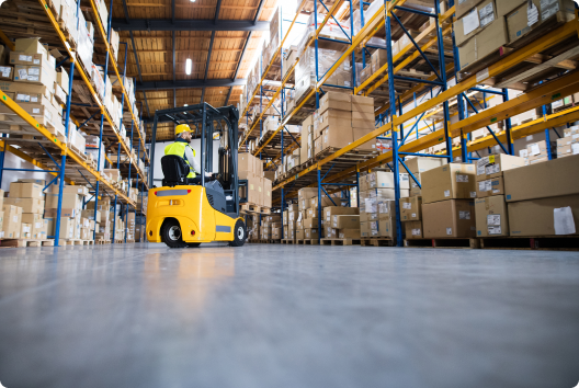 warehouse worker driving a machine through the warehouse