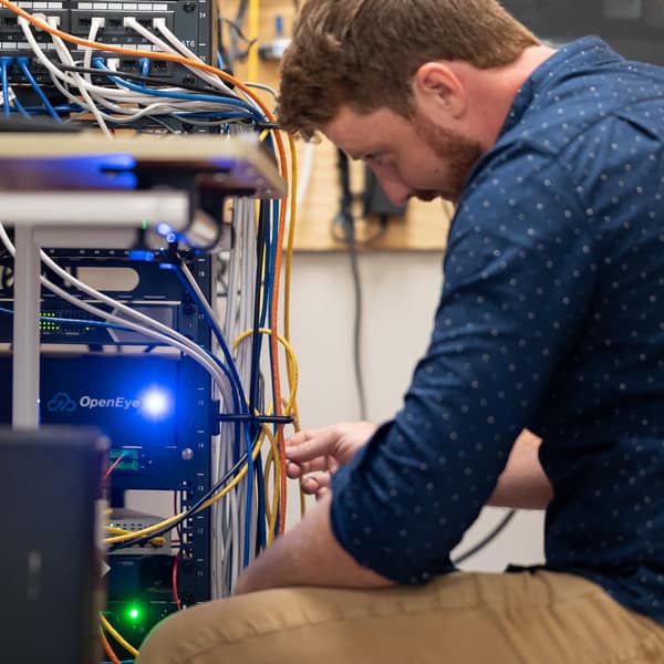technician works on OpenEye system at Hello Credit Union