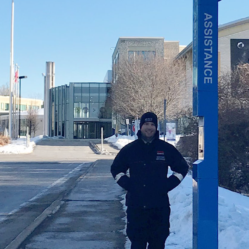 man stands in front of Emergency Station at La Cité College