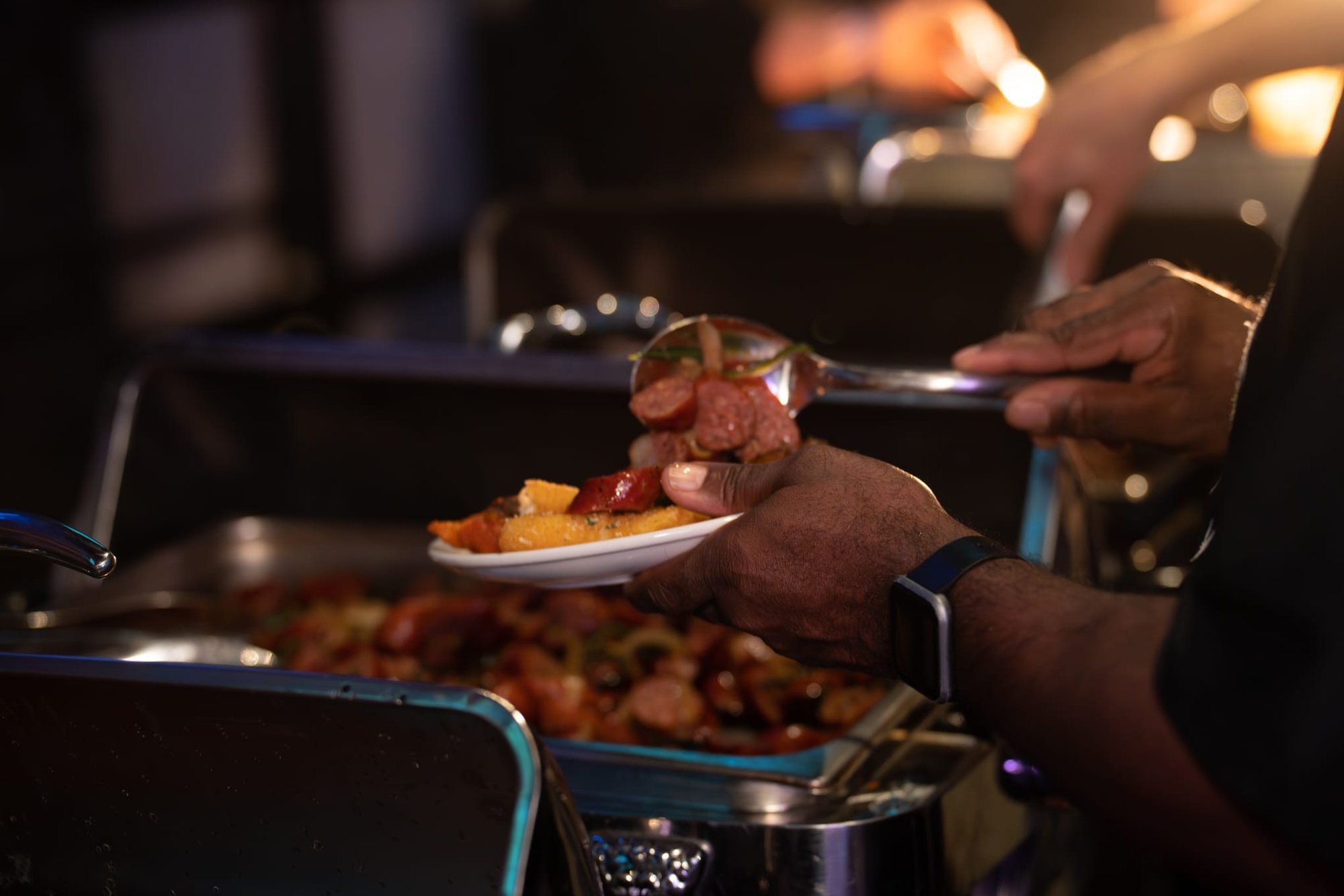 Candid shot of attendees of Security 101 Appreciation Event filling their plates at Happiest Hour in Dallas, TX