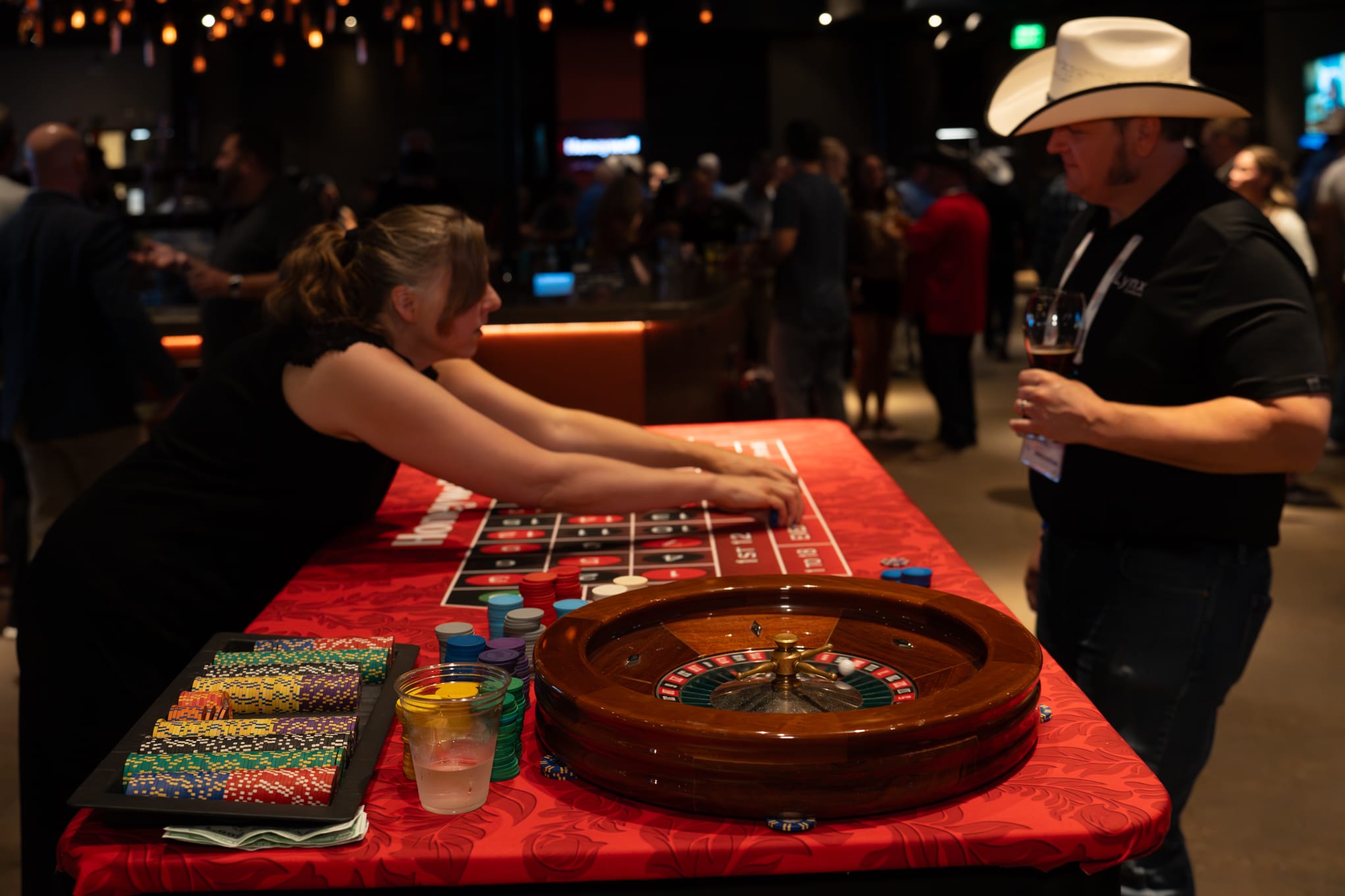 Attendees of Security 101 Appreciation Event participate in casino games at Happiest Hour in Dallas, TX