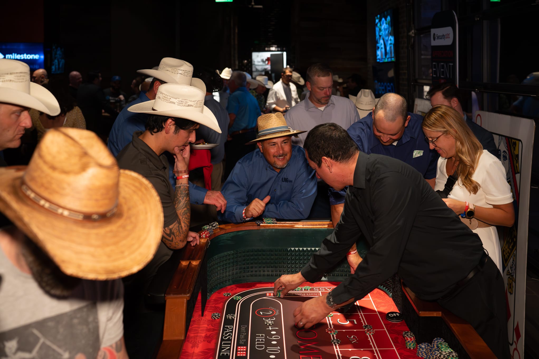 Attendees of Security 101 Appreciation Event participate in casino games at Happiest Hour in Dallas, TX