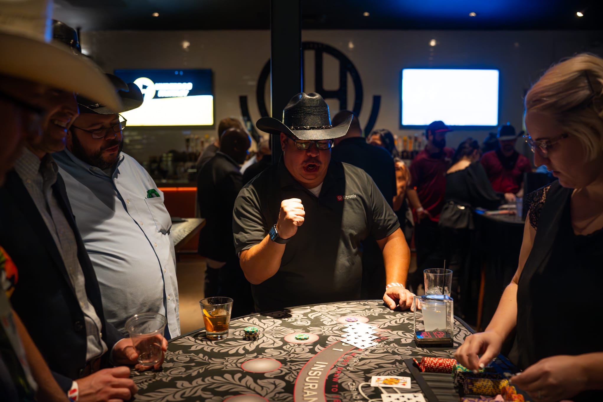 Attendees of Security 101 Appreciation Event participate in casino games at Happiest Hour in Dallas, TX