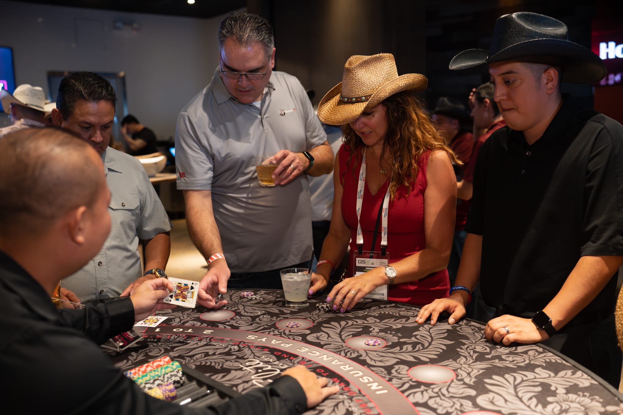 Attendees of Security 101 Appreciation Event participate in casino games at Happiest Hour in Dallas, TX