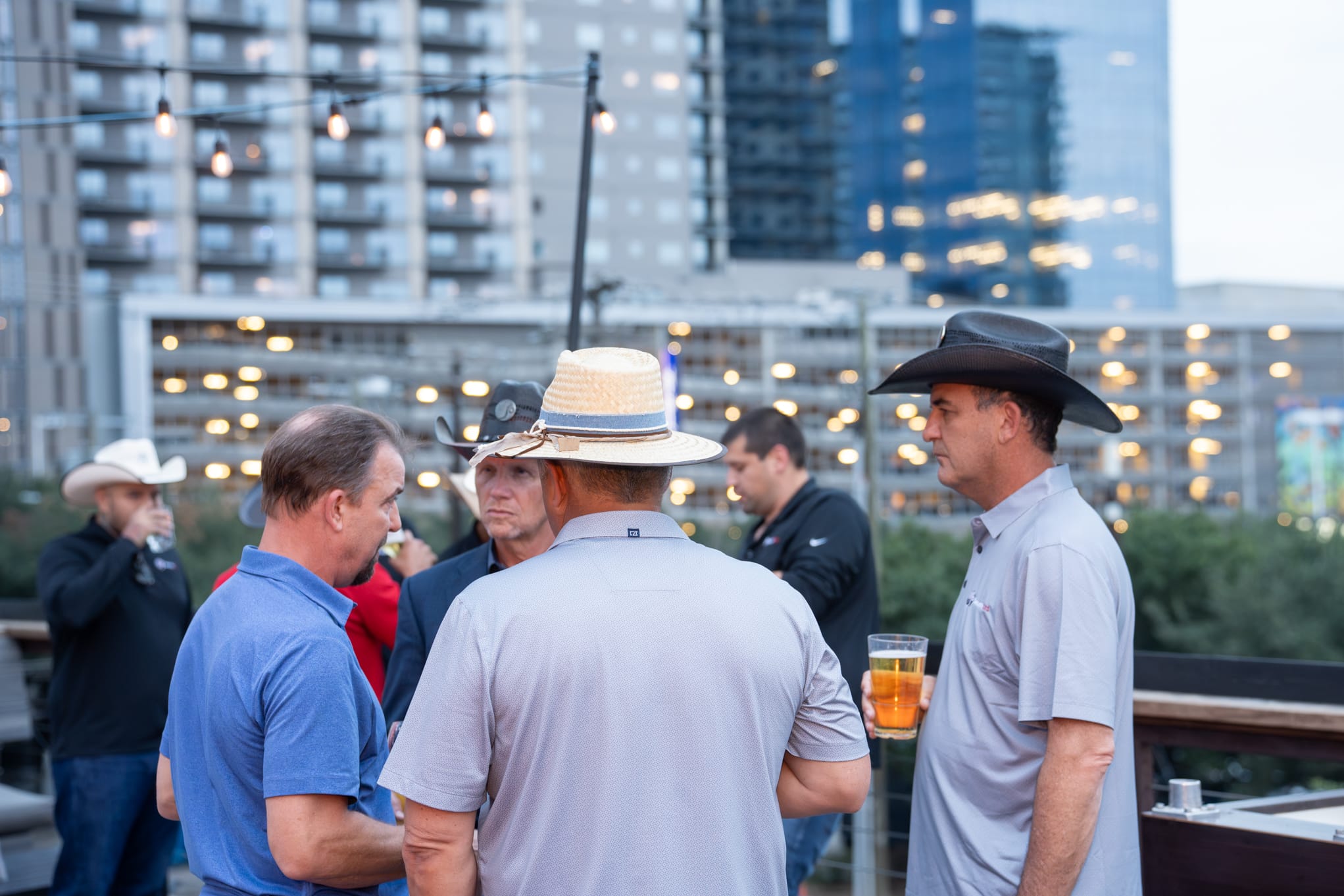 Security 101 Appreciation Event attendees network on the rooftop patio of Happiest Hour in Dallas, TX