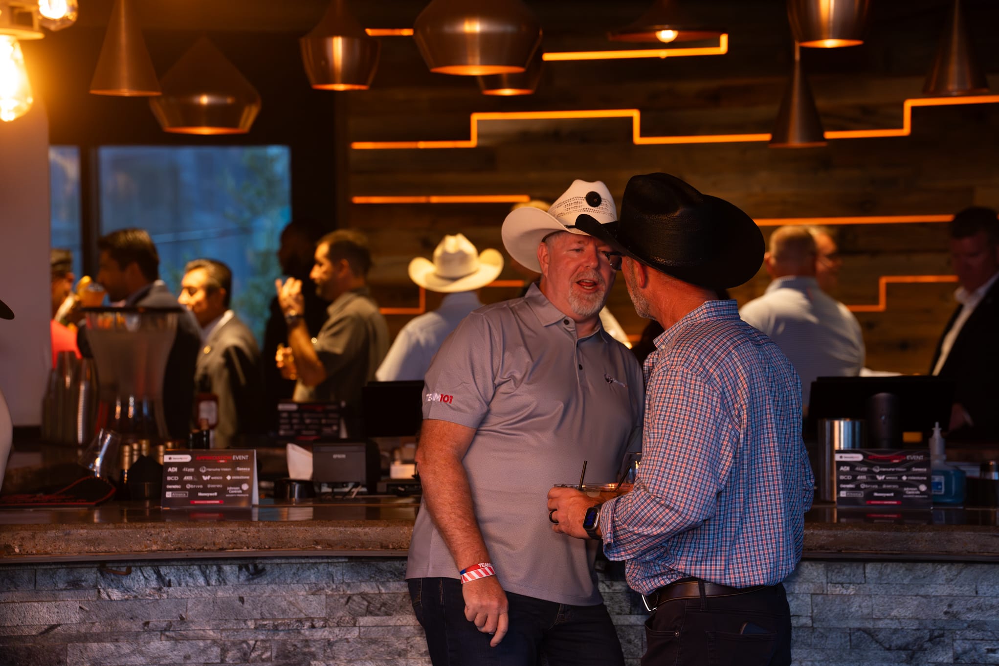 Security 101 Appreciation Event attendees network on the rooftop patio of Happiest Hour in Dallas, TX