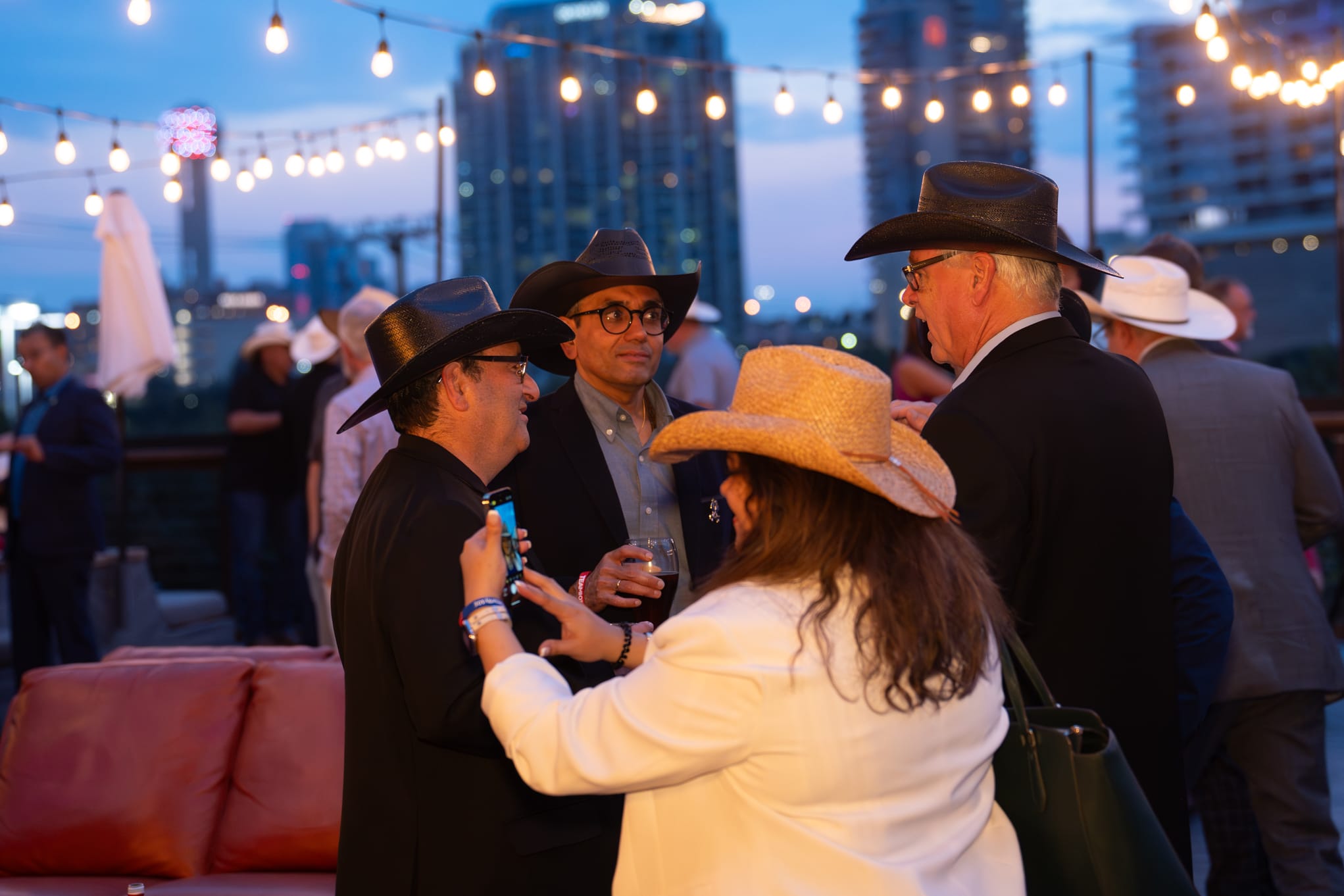 Security 101 Appreciation Event attendees network on the rooftop patio of Happiest Hour in Dallas, TX