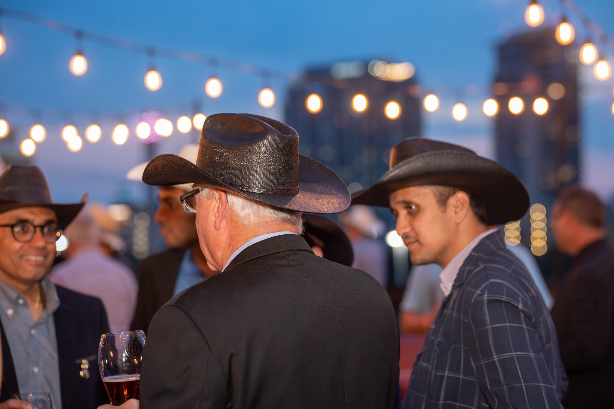 Security 101 Appreciation Event attendees network on the rooftop patio of Happiest Hour in Dallas, TX