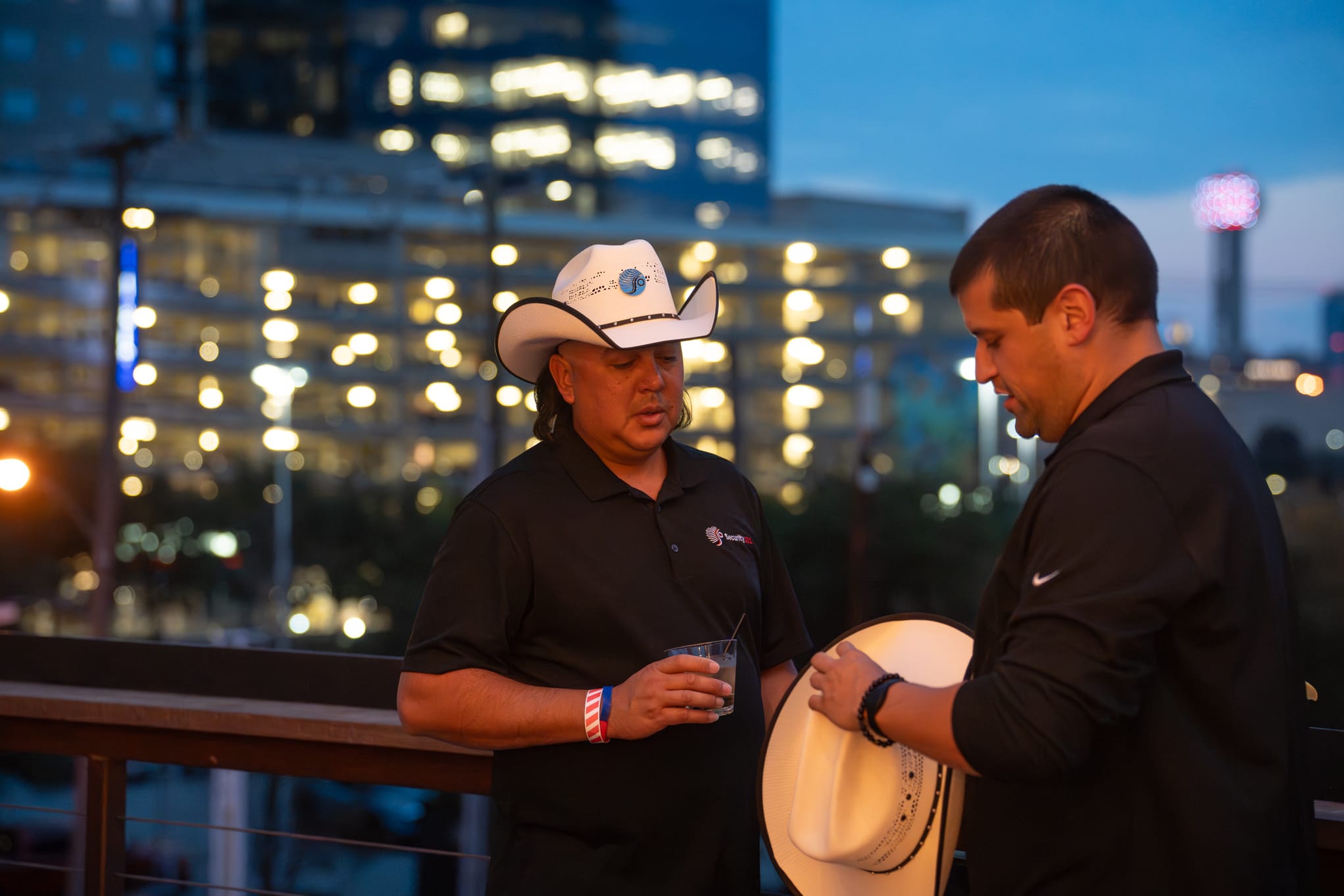 Security 101 Appreciation Event attendees network on the rooftop patio of Happiest Hour in Dallas, TX