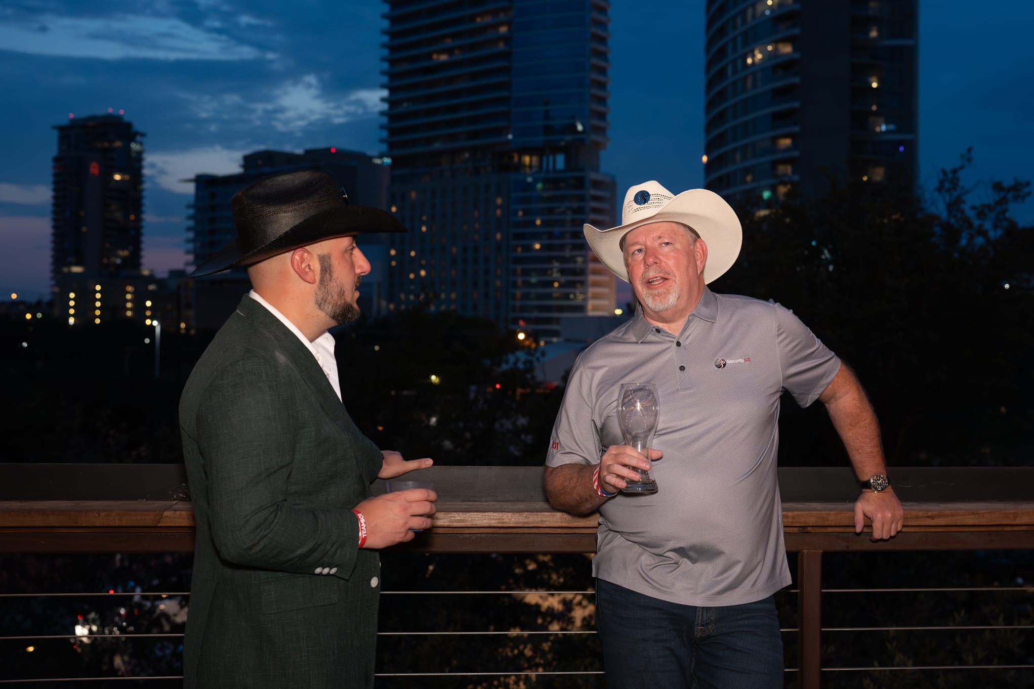 Security 101 Appreciation Event attendees network on the rooftop patio of Happiest Hour in Dallas, TX