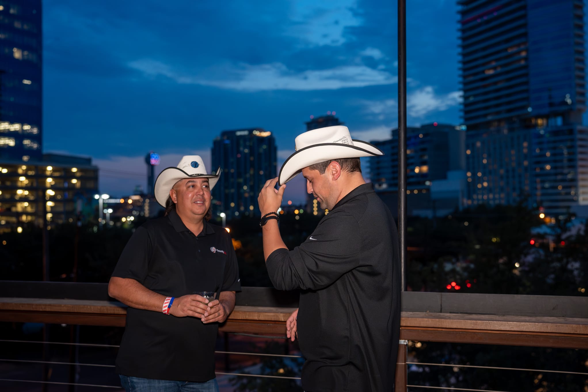 Security 101 Appreciation Event attendees network on the rooftop patio of Happiest Hour in Dallas, TX