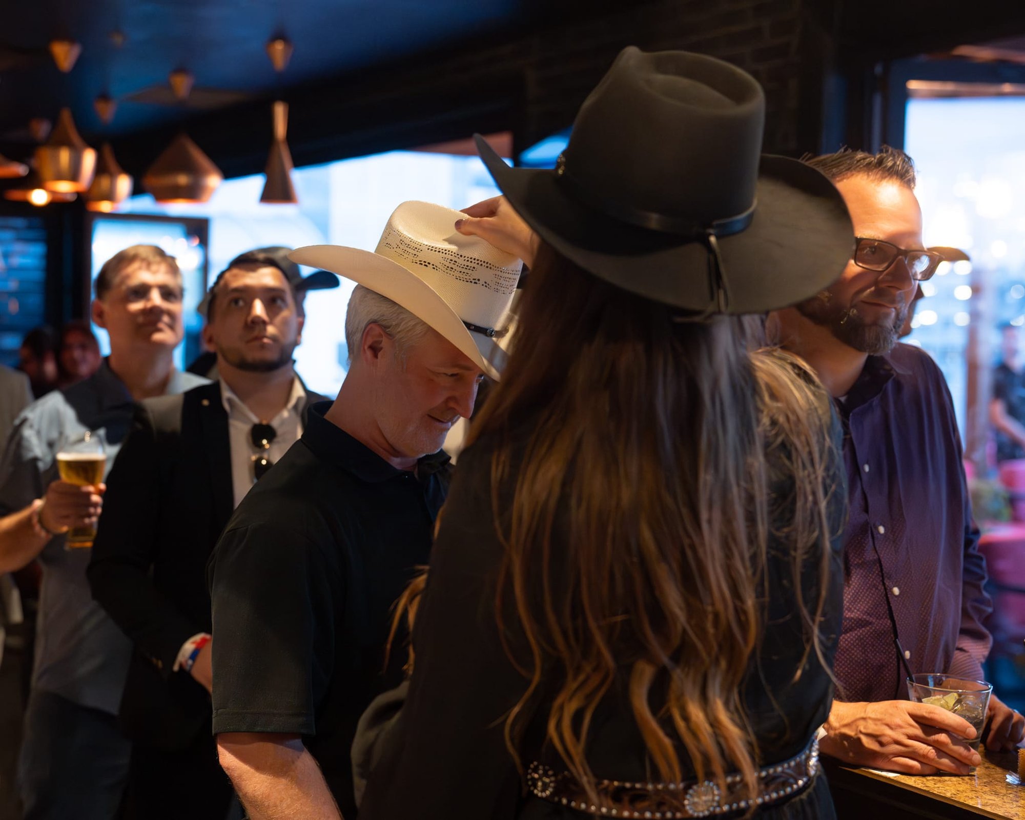 Wild Bill makes custom cowboy hats for Security 101’s Appreciation Event attendees at the Happiest Hour rooftop bar