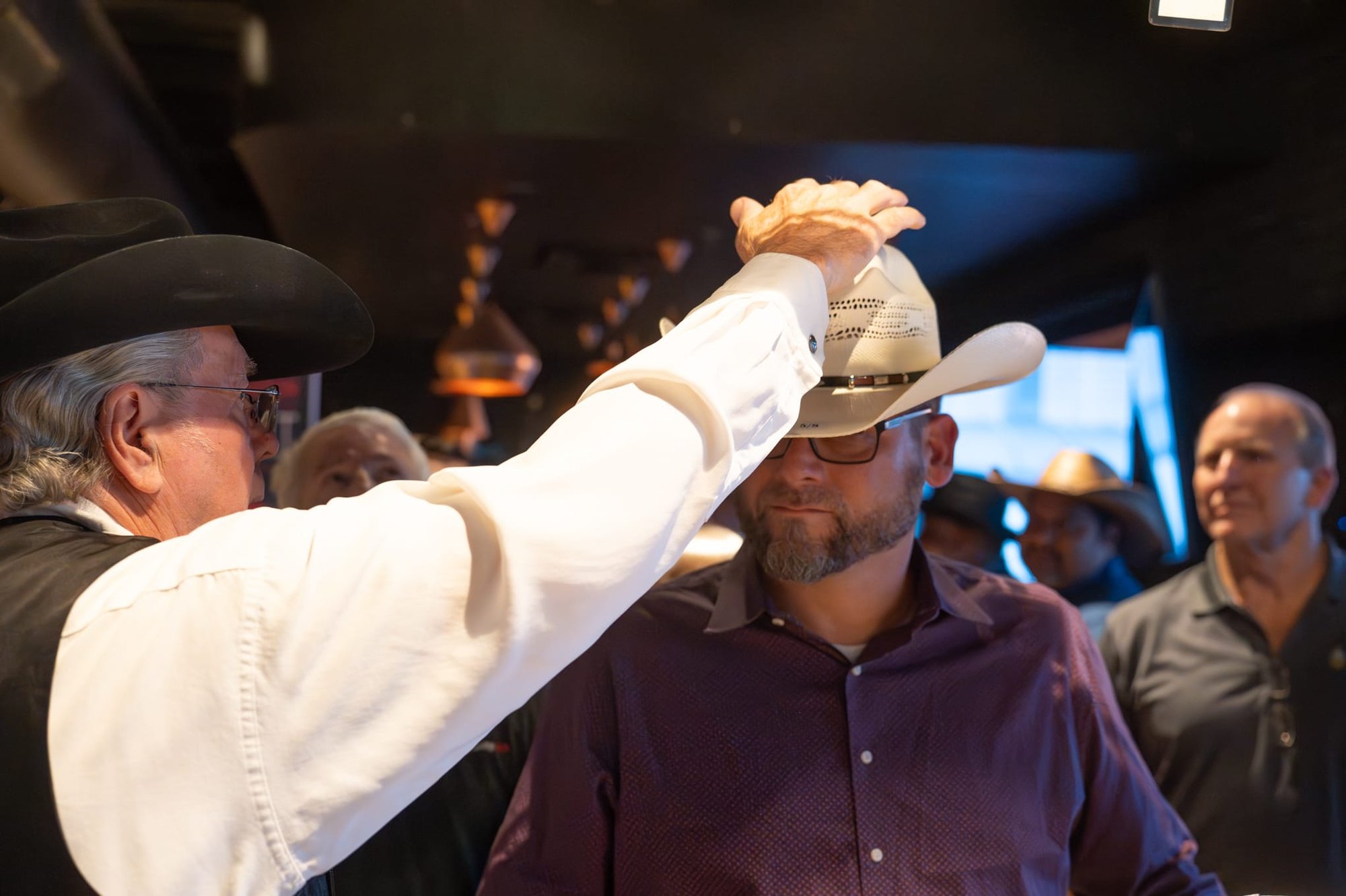 Wild Bill makes custom cowboy hats for Security 101’s Appreciation Event attendees at the Happiest Hour rooftop bar