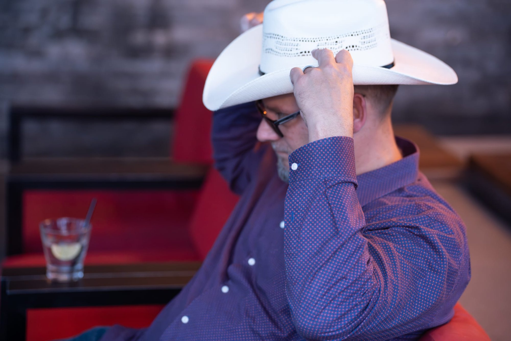 Wild Bill makes custom cowboy hats for Security 101’s Appreciation Event attendees at the Happiest Hour rooftop bar