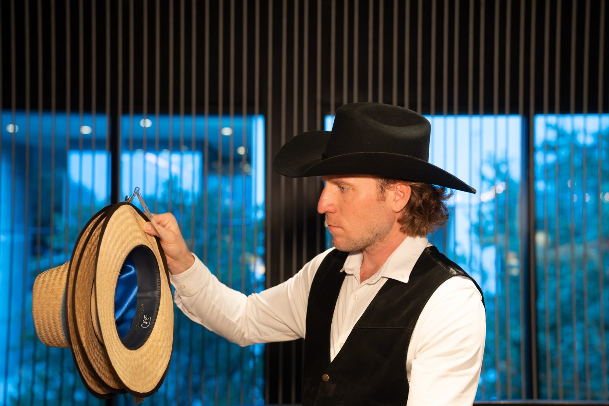 Wild Bill makes custom cowboy hats for Security 101’s Appreciation Event attendees at the Happiest Hour rooftop bar