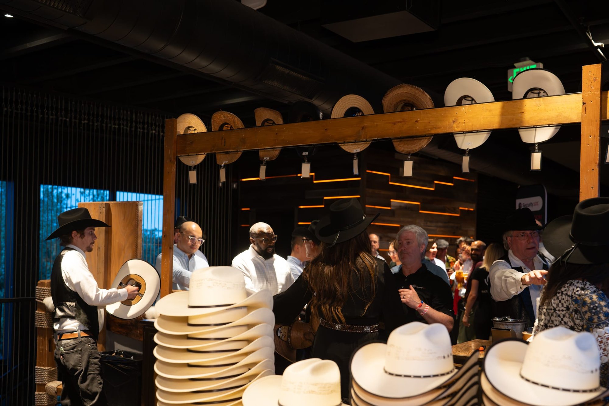 Wild Bill makes custom cowboy hats for Security 101’s Appreciation Event attendees at the Happiest Hour rooftop bar