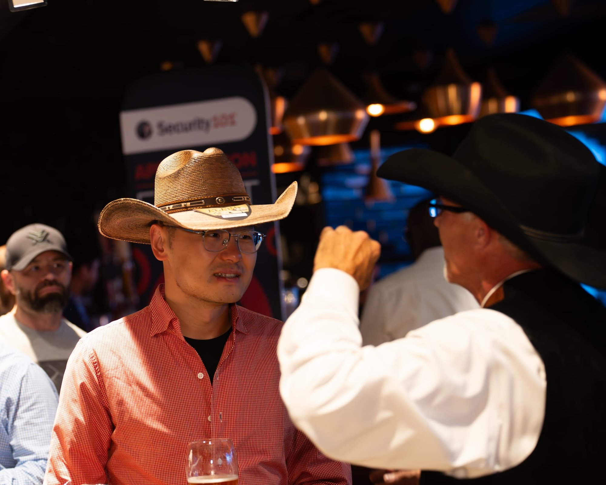 Wild Bill makes custom cowboy hats for Security 101’s Appreciation Event attendees at the Happiest Hour rooftop bar