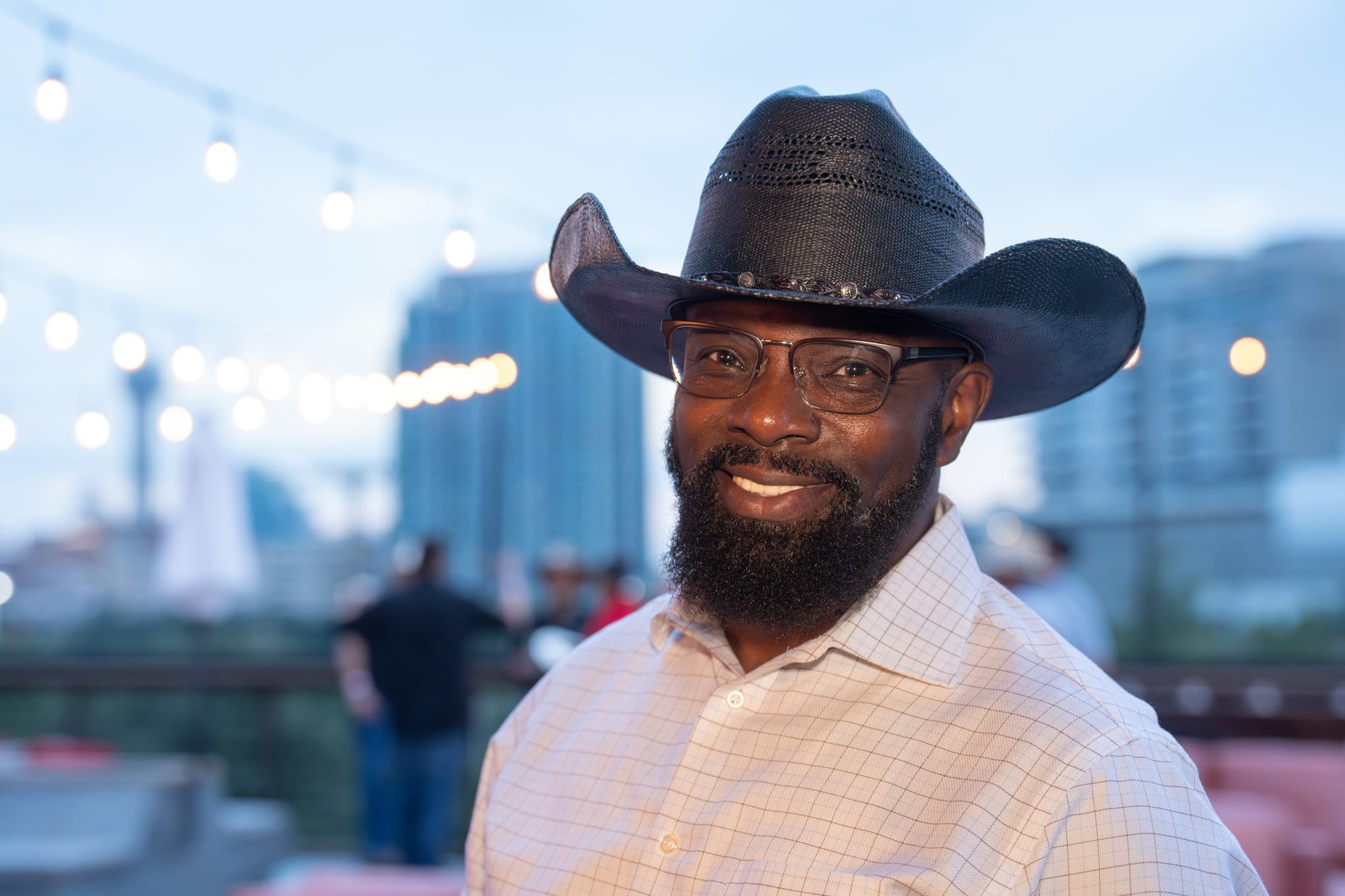 Wild Bill makes custom cowboy hats for Security 101’s Appreciation Event attendees at the Happiest Hour rooftop bar