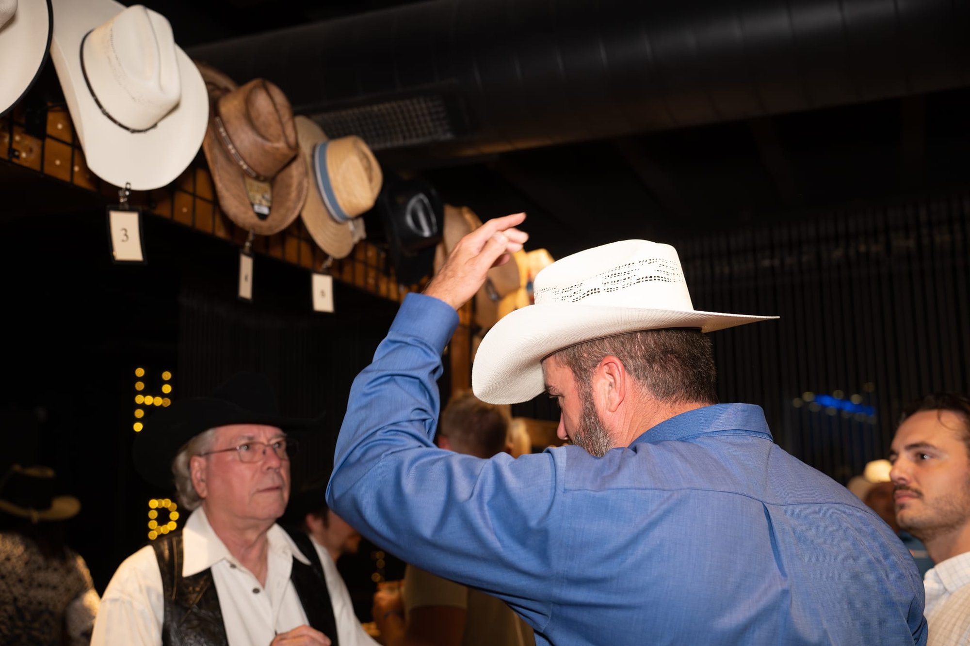 Wild Bill makes custom cowboy hats for Security 101’s Appreciation Event attendees at the Happiest Hour rooftop bar