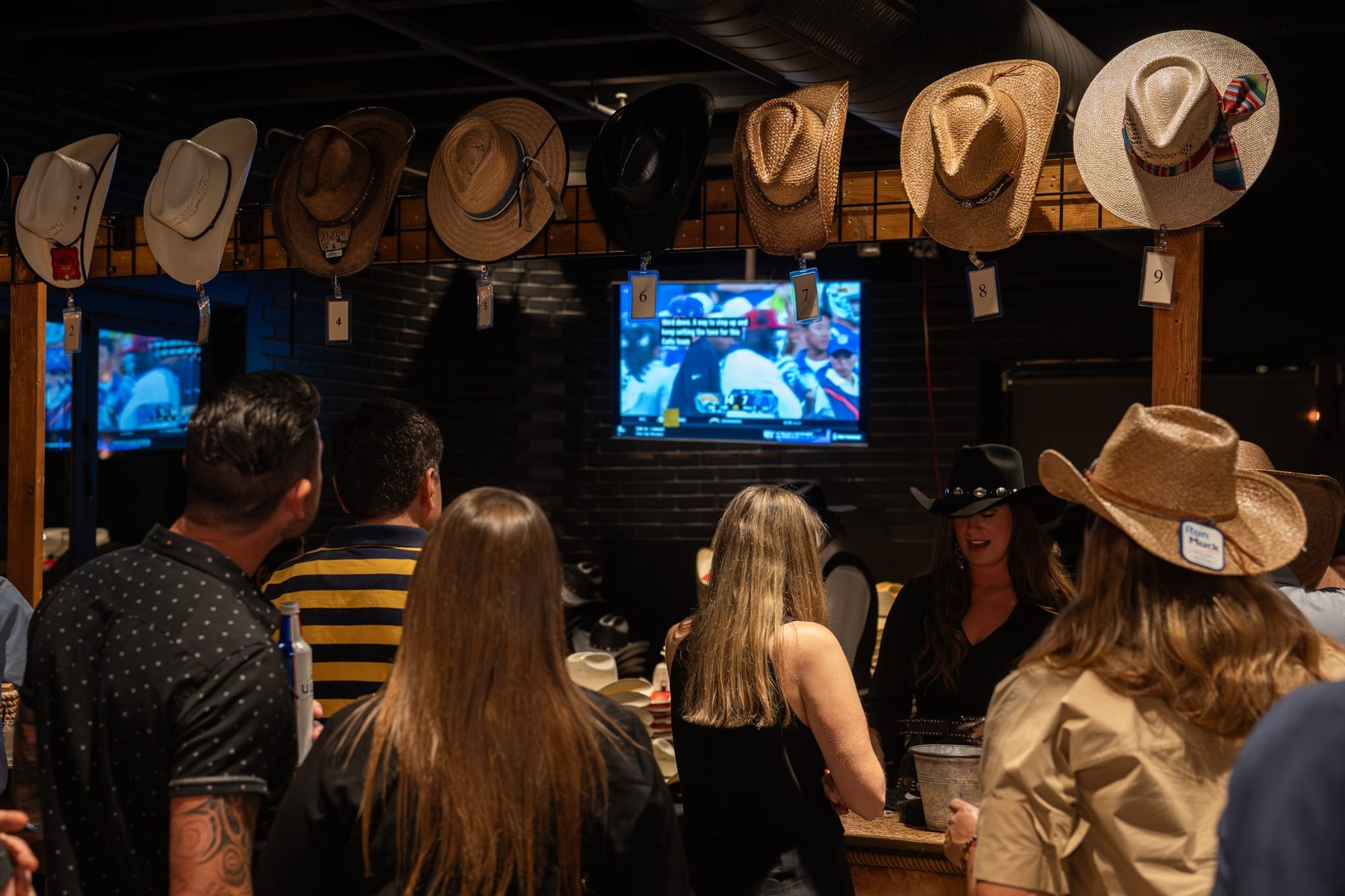 Wild Bill makes custom cowboy hats for Security 101’s Appreciation Event attendees at the Happiest Hour rooftop bar