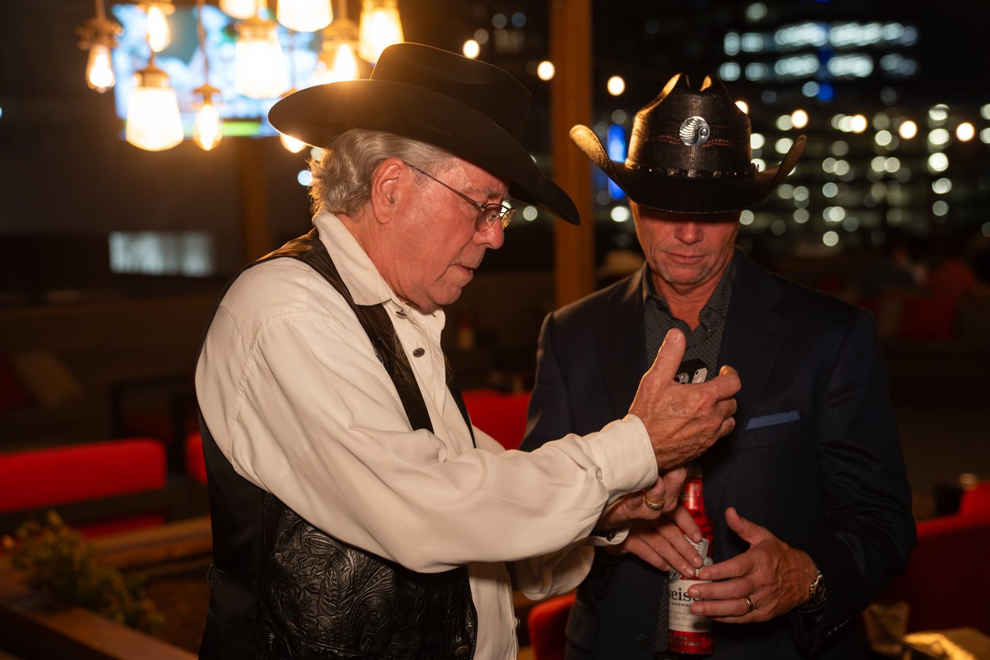 Wild Bill makes custom cowboy hats for Security 101’s Appreciation Event attendees at the Happiest Hour rooftop bar