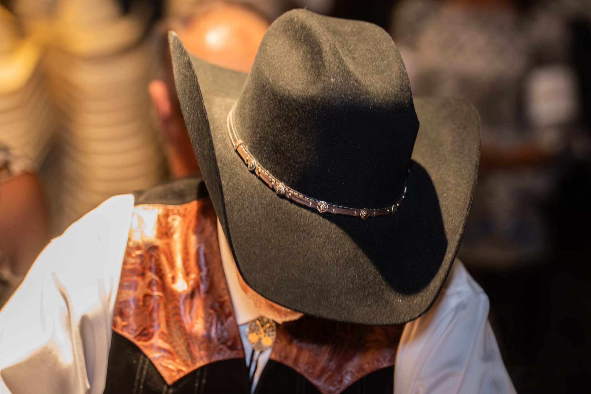 Wild Bill makes custom cowboy hats for Security 101’s Appreciation Event attendees at the Happiest Hour rooftop bar