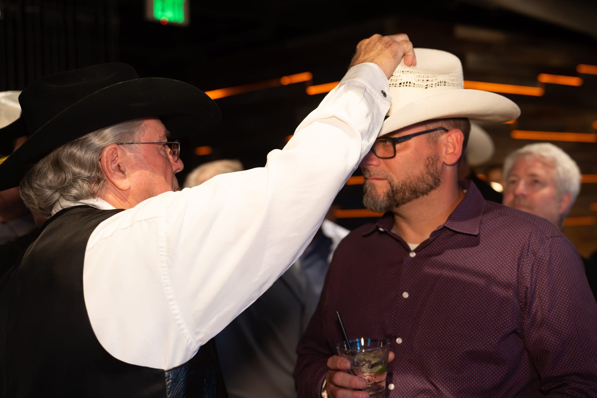 Wild Bill makes custom cowboy hats for Security 101’s Appreciation Event attendees at the Happiest Hour rooftop bar