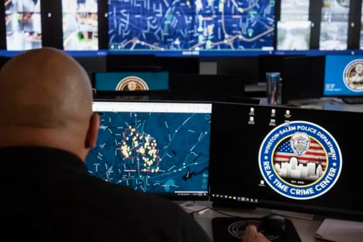 police officer looks at a computer moitor