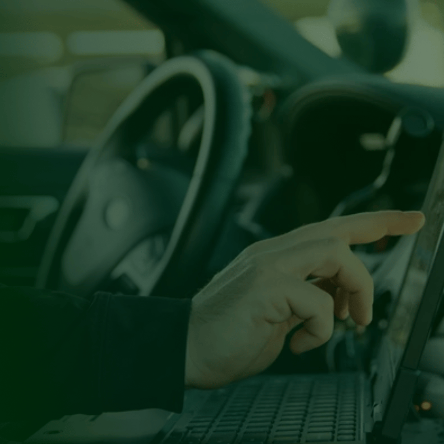 police officer is using their laptop while in their vehicle