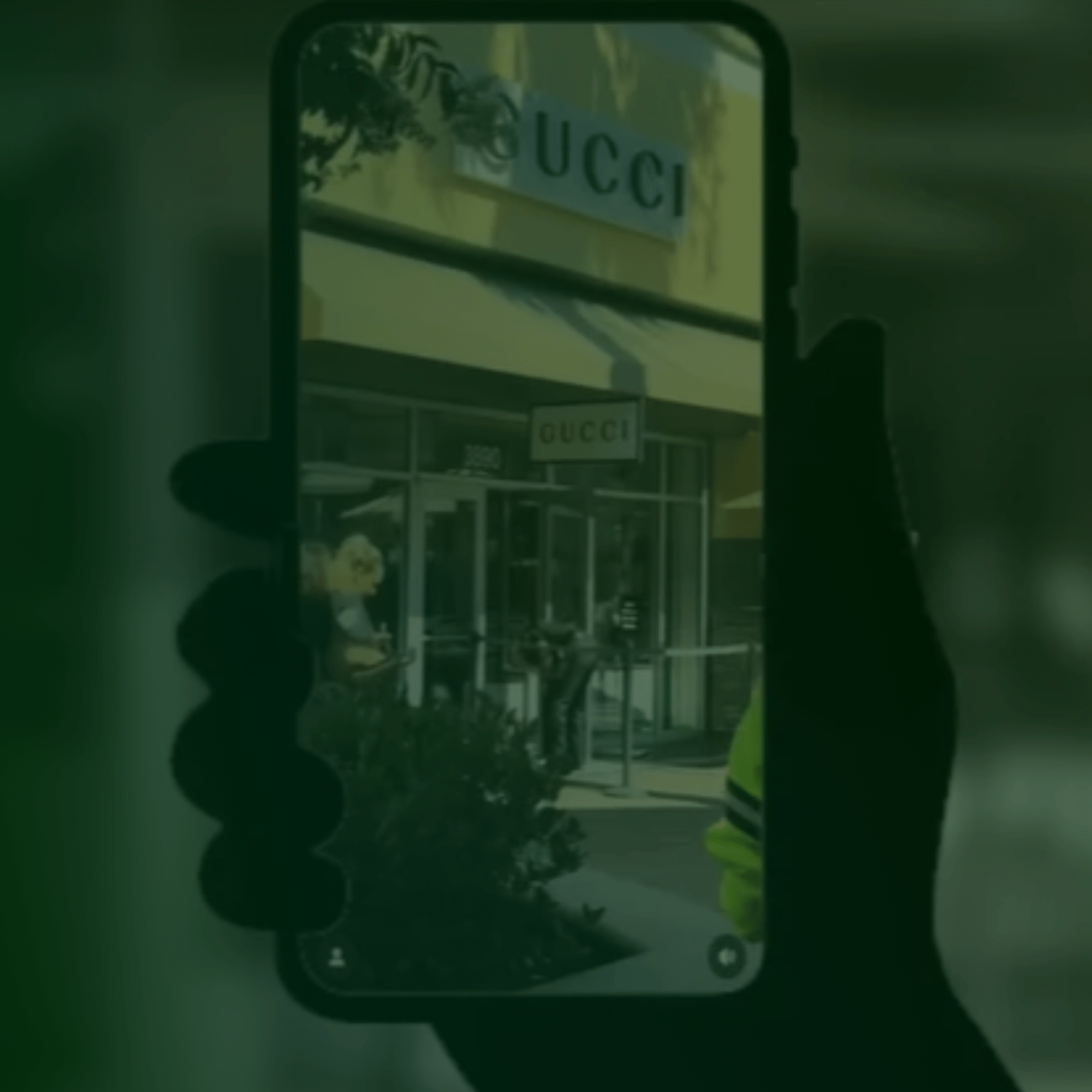 phone screen showing surveillance of a Gucci store